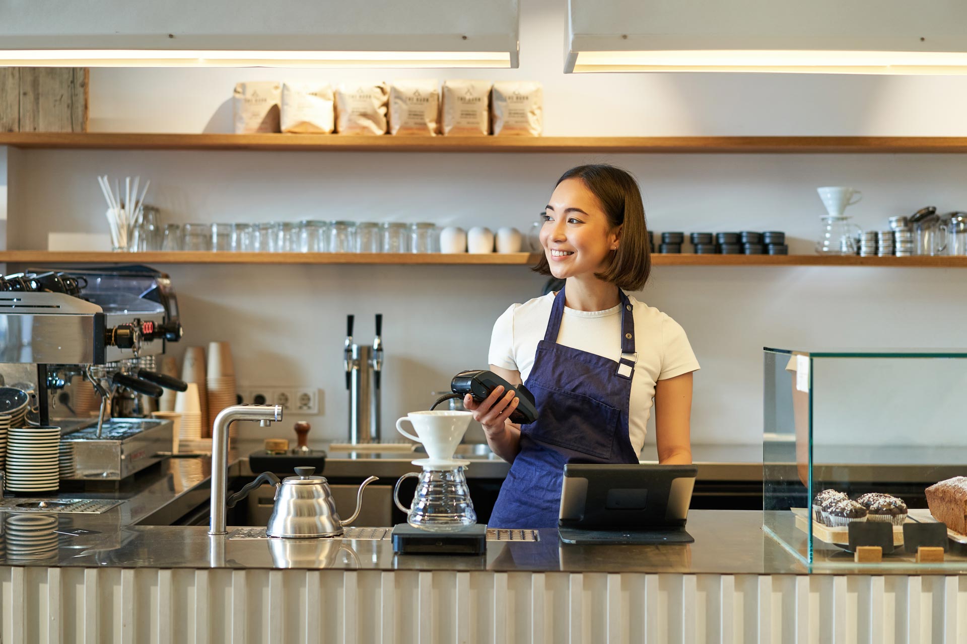 portrait of smiling asian girl barista standing near coffee brewing kit making filter in cafe 1