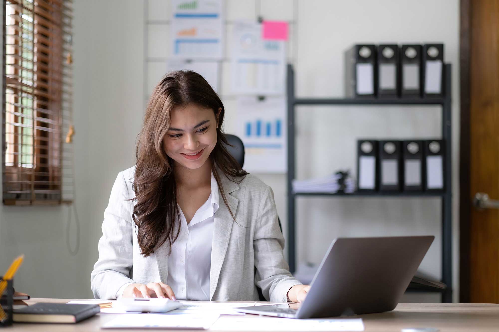 young woman working on a laptop in the office asi 2023 11 27 05 01 46 utc